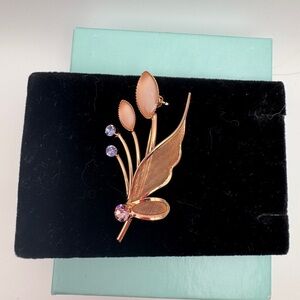 Elegant Rose-Gold and Pink Leaf Brooch with blue and pink-lavender rhinestones